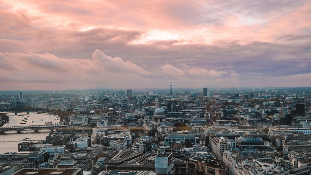 London city centre underneath dramatic, pink, cloudy sky