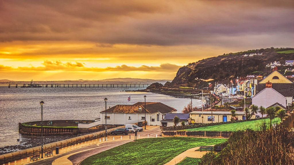 Dramatic yellow sunset behind a coastal town
